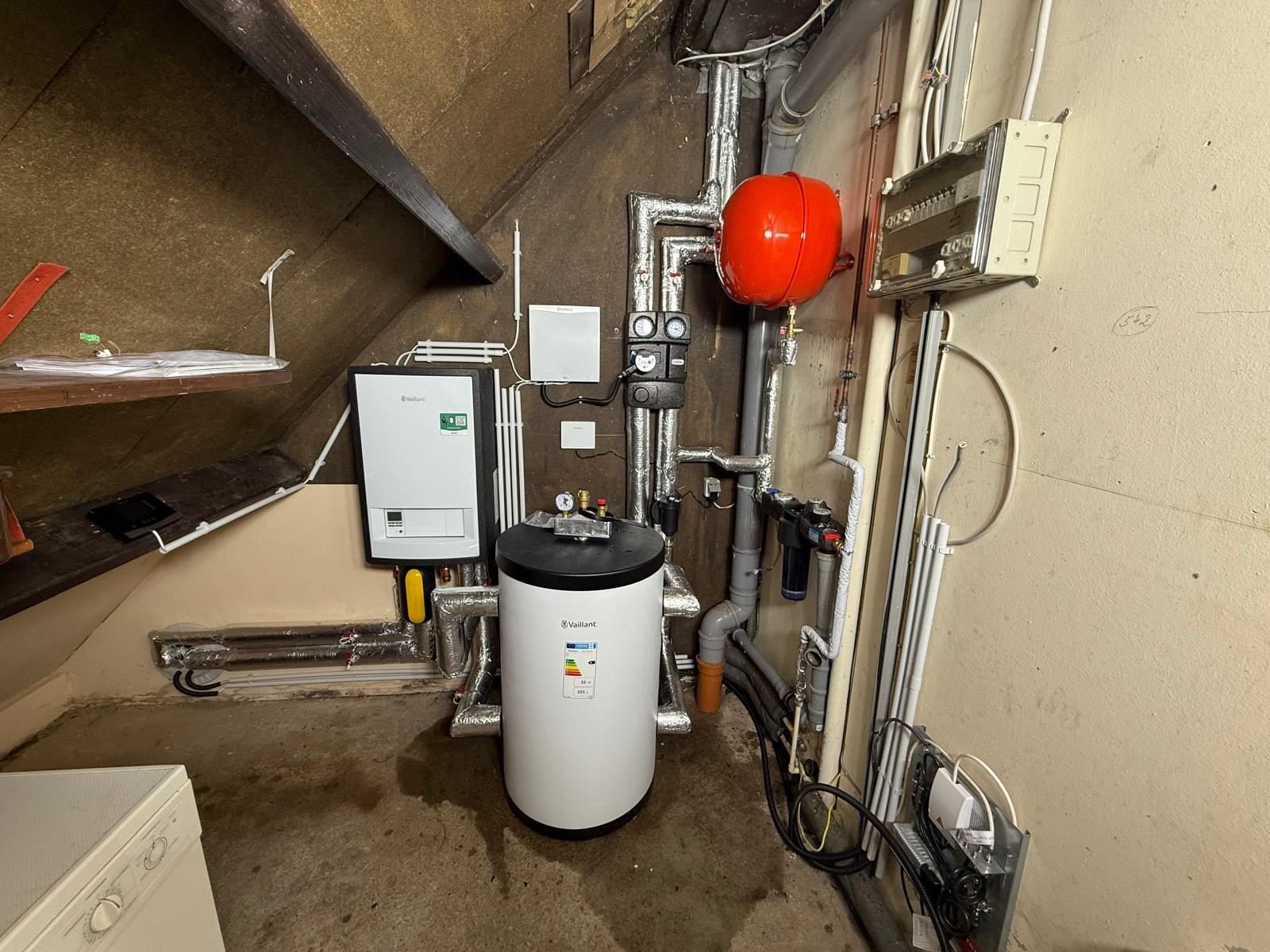 Vaillant-Inneneinheit und Warmwasserspeicher im kleinen Heizraum unter der Treppe in Beverungen